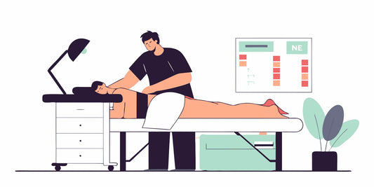 Professional bodywork treatment room with modern equipment and a practitioner adjusting a vibration therapy device